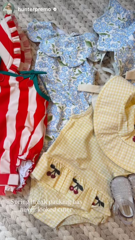 Collection of children's clothing and accessories on a textured surface with 'hunterpremo' branding.